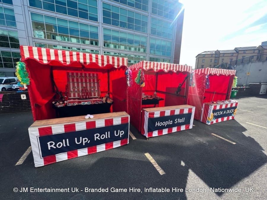 Row of red and white fairground side stalls for hire in the North East